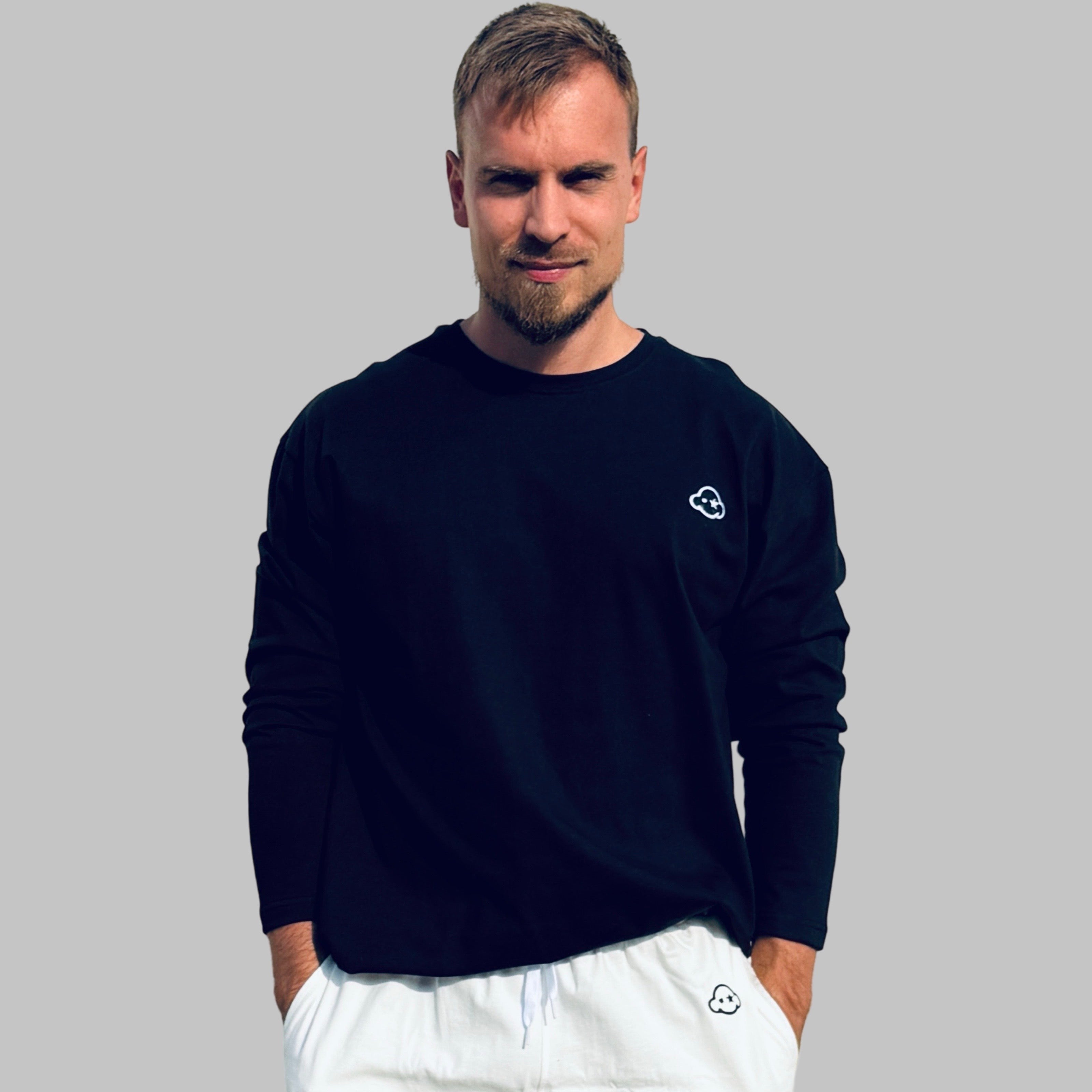 White cotton activewear pants with a small black logo on the left leg, featuring a relaxed fit and drawstring waist. 100% Cotton available in Dubai same day delivery best of summer and winter casual streetwear unisex men and women shorts and t-shirts available in UAE fast delivery and same day delivery available Pants joggers jogger pants