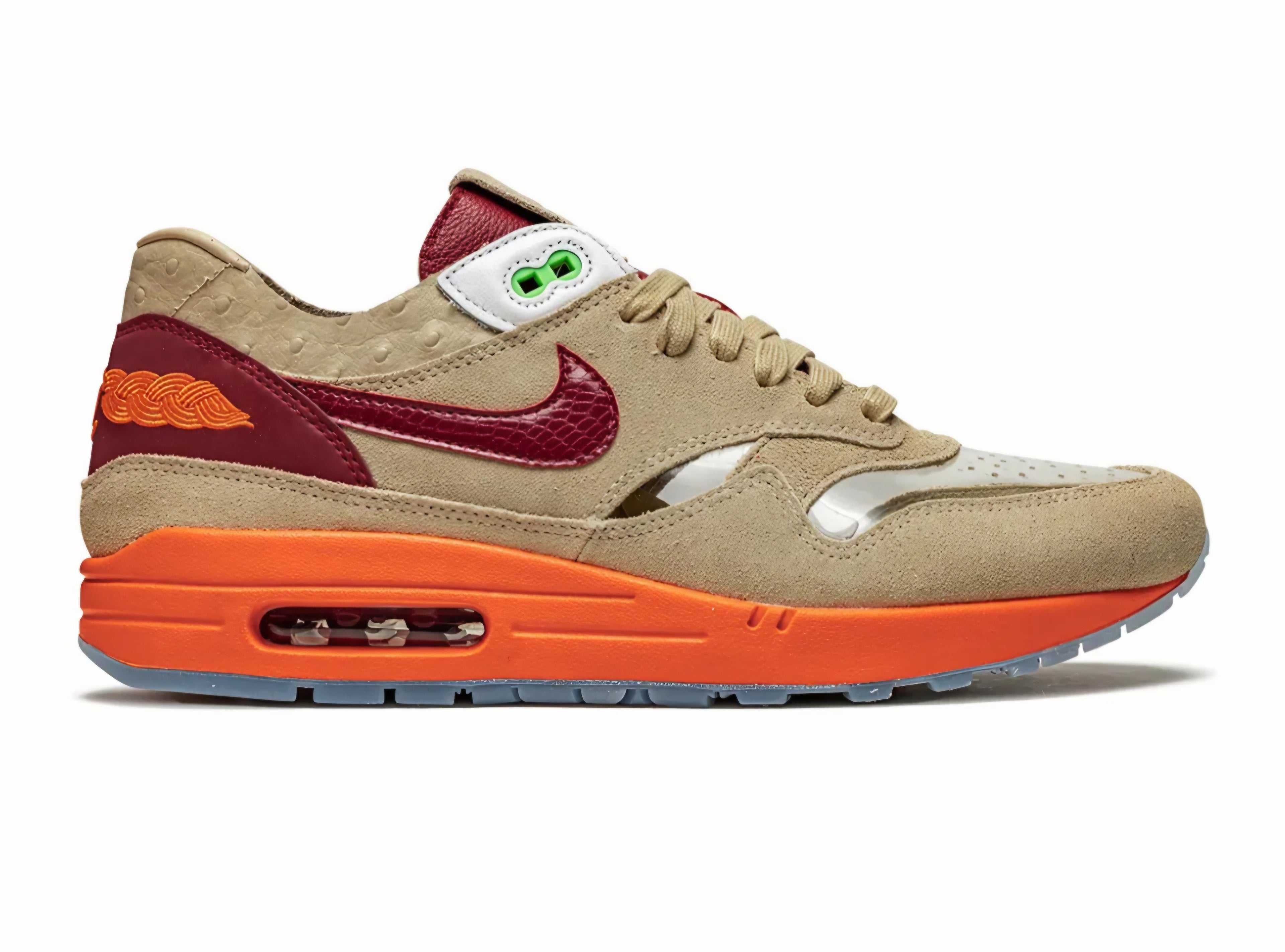 Beige sneaker with orange sole and maroon swoosh logo on a white background. Nike shoes Jordans dunks