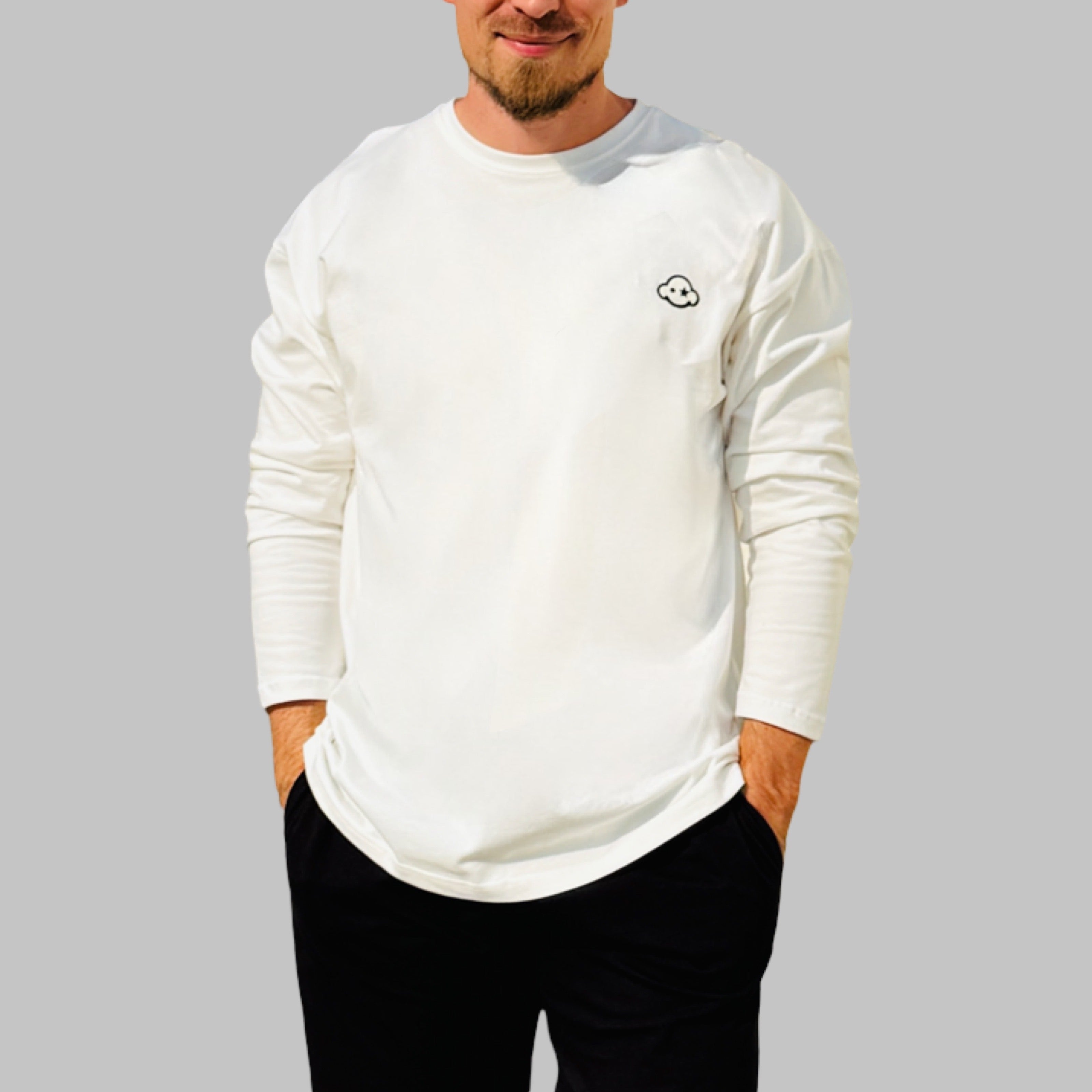 White cotton activewear pants with a small black logo on the left leg, featuring a relaxed fit and drawstring waist. 100% Cotton available in Dubai same day delivery best of summer and winter casual streetwear unisex men and women shorts and t-shirts available in UAE fast delivery and same day delivery available Pants joggers jogger pants