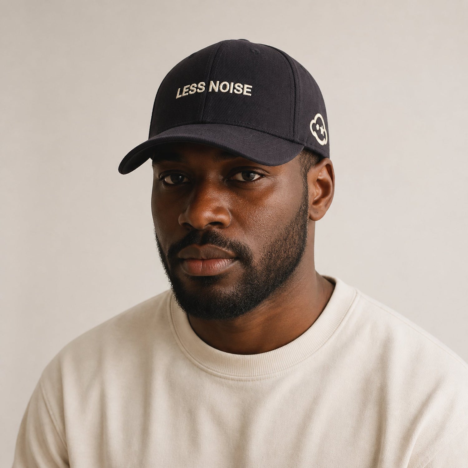 Less Noise black classic cap worn by model