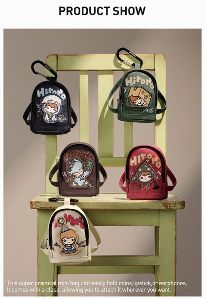 Set of small backpacks with character designs on a wooden chair.  Collectible Labubu pop mart toys Hirono 