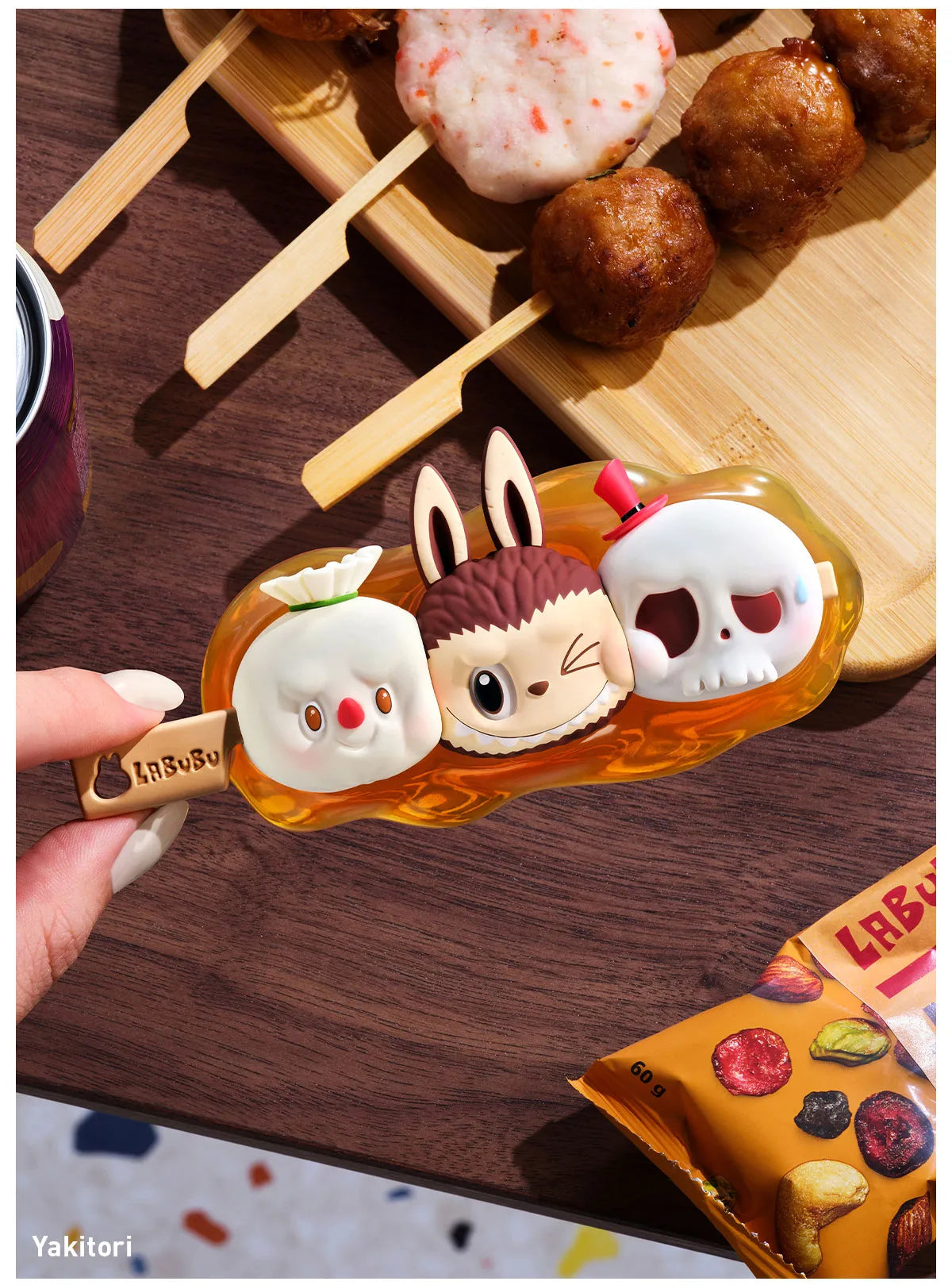 Kawaii-style skewer holder with cartoon character design on a wooden surface with yakitori skewers.  Collectible Labubu pop mart toys