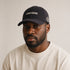 Less Noise black classic cap worn by model – front view