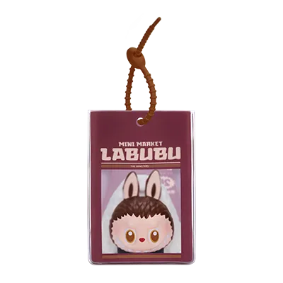 Miniature book with cartoon character on a white background. Collectible Labubu pop mart toys lanyard