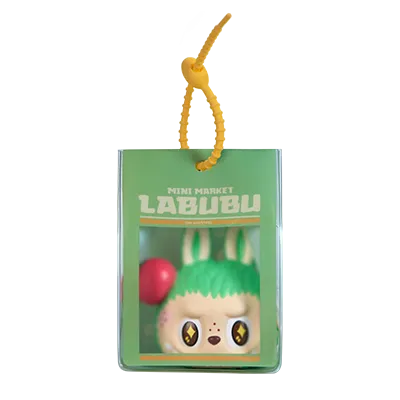 Miniature Labubu toy with green head and red ball, hanging from a yellow string on a white background. Collectible Labubu pop mart toys lanyard