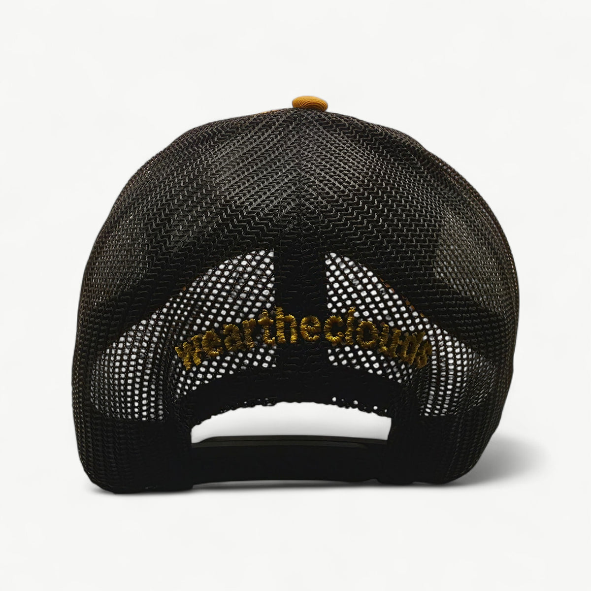 Never Settle mustard and black trucker cap – back view with weartheclouds logo