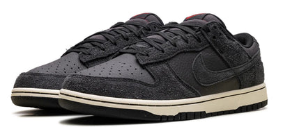 Black Nike sneakers with a white sole on a white background