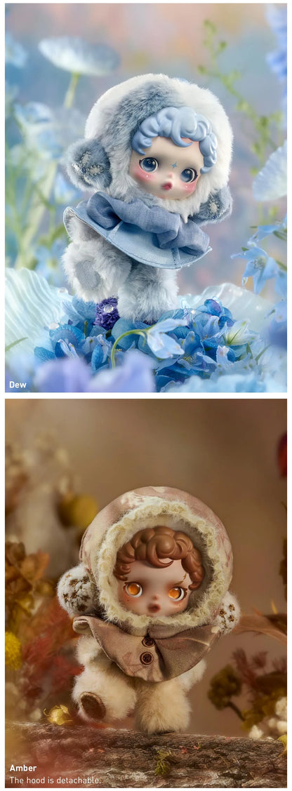 Two miniature figurines in winter-themed outfits with snowflakes and floral backgrounds. SkullPanda Toys Collectibles Dubai Rare Labubu