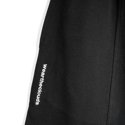 White cotton activewear pants with a small black logo on the left leg, featuring a relaxed fit and drawstring waist. 100% Cotton available in Dubai same day delivery best of summer and winter casual streetwear unisex men and women shorts and t-shirts available in UAE fast delivery and same day delivery available Pants joggers jogger pants