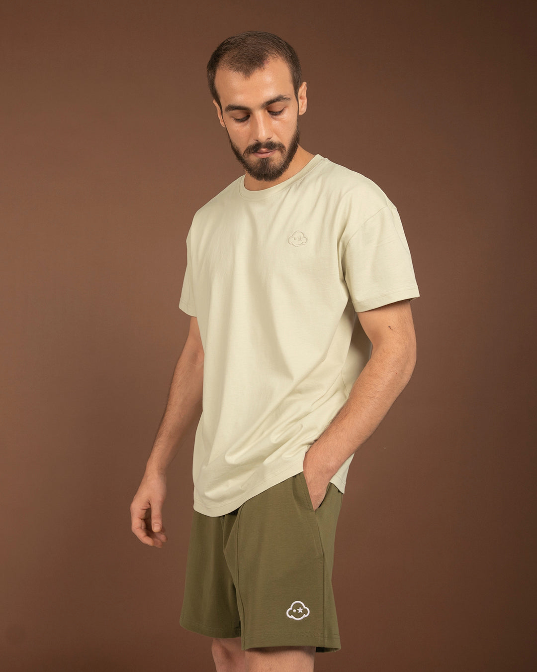 White cotton activewear pants with a small black logo on the left leg, featuring a relaxed fit and drawstring waist. 100% Cotton available in Dubai same day delivery best of summer and winter casual streetwear unisex men and women shorts and t-shirts available in UAE fast delivery and same day delivery available Pants joggers jogger pants