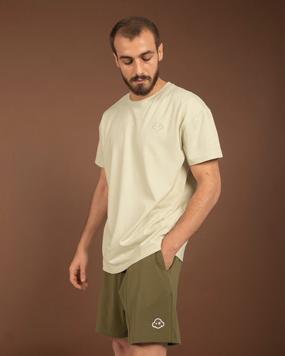 White cotton activewear pants with a small black logo on the left leg, featuring a relaxed fit and drawstring waist. 100% Cotton available in Dubai same day delivery best of summer and winter casual streetwear unisex men and women shorts and t-shirts available in UAE fast delivery and same day delivery available Pants joggers jogger pants