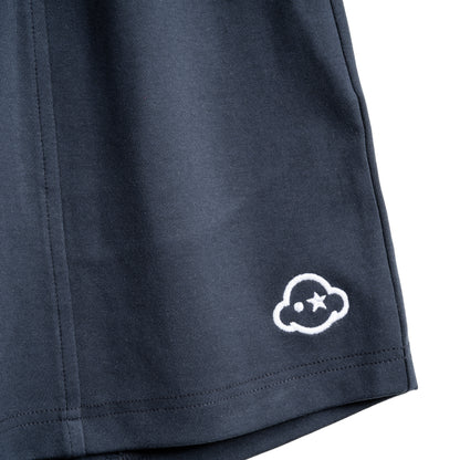 Navy blue cotton loungewear shorts with a relaxed fit, mid-rise, elastic waist, and drawstring. They feature a 3D effect logo embroidered on the left leg and the brand on the right. White cotton activewear pants with a small black logo on the left leg, featuring a relaxed fit and drawstring waist. 100% Cotton available in Dubai same day delivery best of summer and winter casual streetwear unisex men and women shorts and t-shirts available in UAE fast delivery and same day delivery available Pants joggers.
