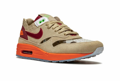 Beige and orange sneaker with red accents on a white background