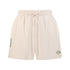 Creamy beige cotton loungewear shorts with elastic waist and drawstring, featuring a small logo embroidered on the left leg and the brand name on the right. White cotton activewear pants with a small black logo on the left leg, featuring a relaxed fit and drawstring waist. 100% Cotton available in Dubai same day delivery best of summer and winter casual streetwear unisex men and women shorts and t-shirts available in UAE fast delivery and same day delivery available Pants joggers jogger pants