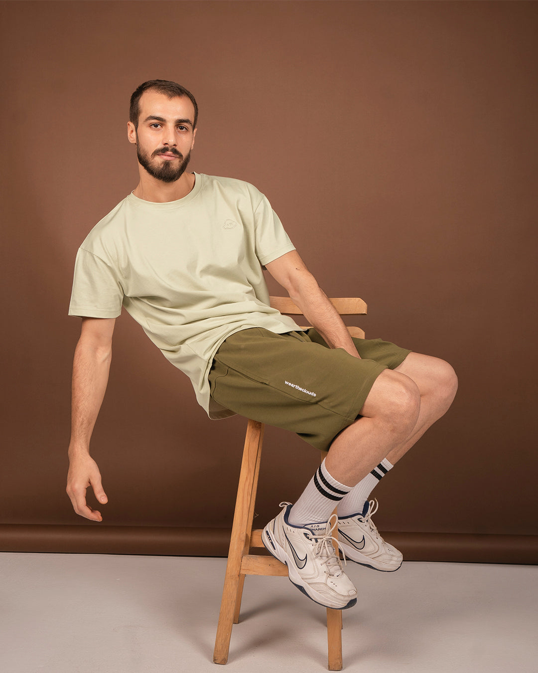 White cotton activewear pants with a small black logo on the left leg, featuring a relaxed fit and drawstring waist. 100% Cotton available in Dubai same day delivery best of summer and winter casual streetwear unisex men and women shorts and t-shirts available in UAE fast delivery and same day delivery available Pants joggers jogger pants