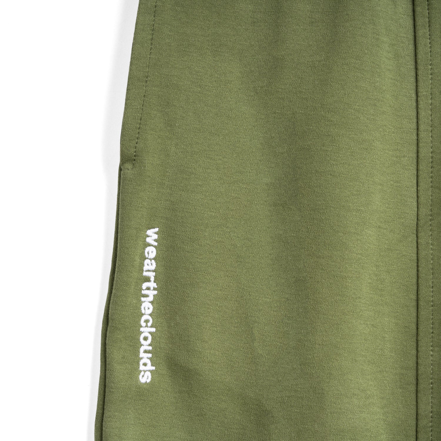 White cotton activewear pants with a small black logo on the left leg, featuring a relaxed fit and drawstring waist. 100% Cotton available in Dubai same day delivery best of summer and winter casual streetwear unisex men and women shorts and t-shirts available in UAE fast delivery and same day delivery available Pants joggers jogger pants