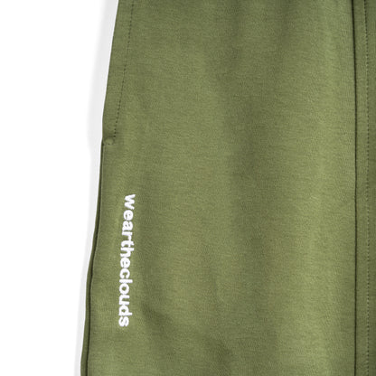 White cotton activewear pants with a small black logo on the left leg, featuring a relaxed fit and drawstring waist. 100% Cotton available in Dubai same day delivery best of summer and winter casual streetwear unisex men and women shorts and t-shirts available in UAE fast delivery and same day delivery available Pants joggers jogger pants