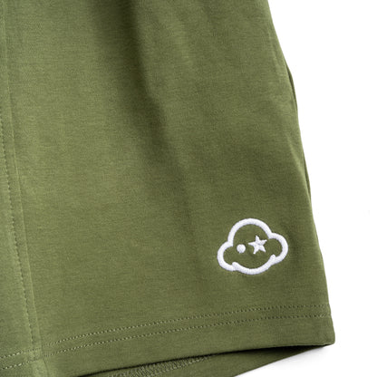 Olive green cotton shorts with a drawstring waist, featuring a small embroidered logo on the left leg and the brand name on the right leg. White cotton activewear pants with a small black logo on the left leg, featuring a relaxed fit and drawstring waist. 100% Cotton available in Dubai same day delivery best of summer and winter casual streetwear unisex men and women shorts and t-shirts available in UAE fast delivery and same day delivery available Pants joggers jogger pants
